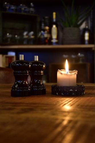 a candle sitting on top of a wooden table at Hotel Schaumburg in Holstebro