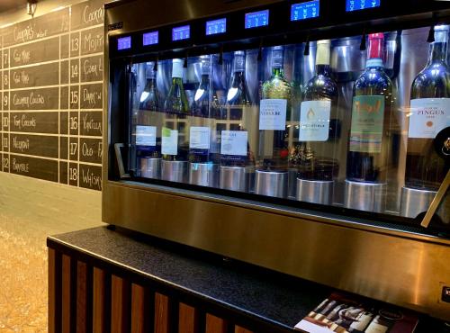 a display of wine bottles in a display case at Hotel Schaumburg in Holstebro