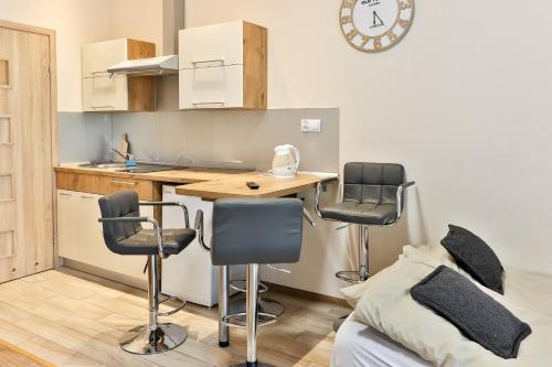 a kitchen with a table and chairs in a room at Rajski Zakątek in Ustroń