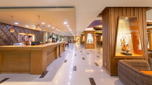 a lobby of a store with a long counter at Khum Phucome Hotel -SHA Extra Plus in Chiang Mai