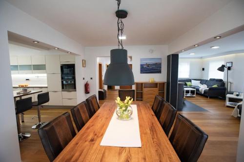 a dining room and living room with a table and chairs at House of Adventure - The Base to explore Slovenia in Laze v Tuhinju