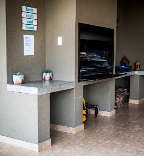 a counter in a fast food restaurant with two plants at Crocodile Bend in Mpakeni