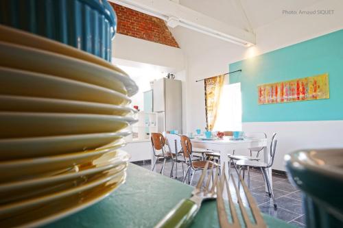 a stack of plates on a table in a dining room at Gîte Biafaux in Saint-Denis