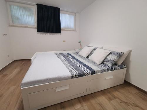 a large bed in a bedroom with white walls at Residenza Sant'Angelo in Citta' Sant'Angelo