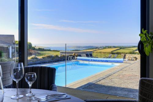a restaurant with a view of a swimming pool at The Pickwick Inn & Oliver's Restaurant in Padstow