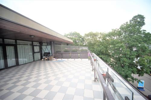 an empty balcony of a building with trees in the background at Amazing location next to the beach jomas str in Jūrmala