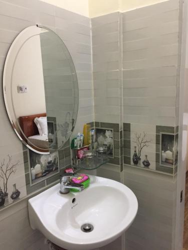 a bathroom with a white sink and a mirror at Khách sạn Ngọc Thương in Quy Nhon