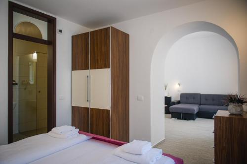 a bedroom with a bed and a living room at Villa Andor in Ankaran