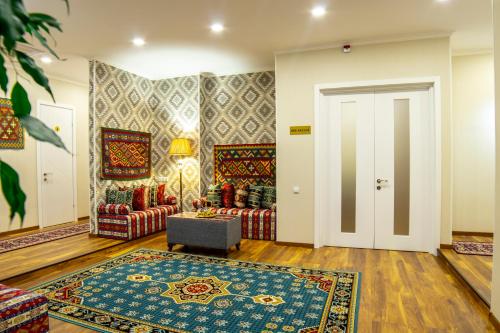 a living room with two couches and a door at Irmisa Hotel Tbilisi in Tbilisi City