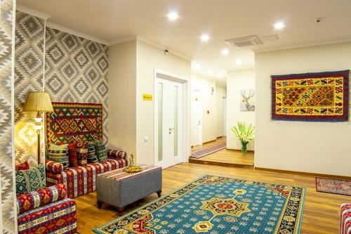 a living room with a couch and a rug at Irmisa Hotel Tbilisi in Tbilisi City