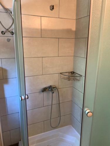 a shower with a shower head in a bathroom at Holiday Home Kite House in Ulcinj