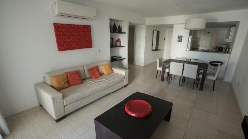 a living room with a couch and a table at Sea Point By D&G in Carilo