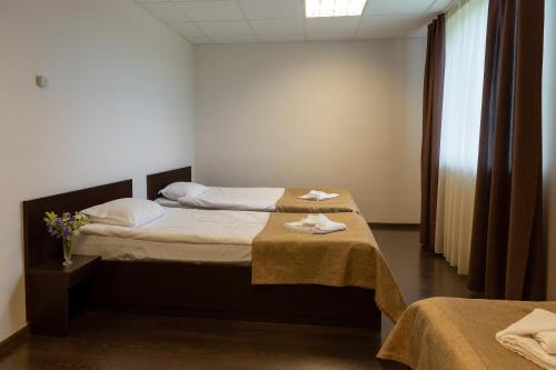 a bedroom with two beds with towels on them at Motovilla in Toila