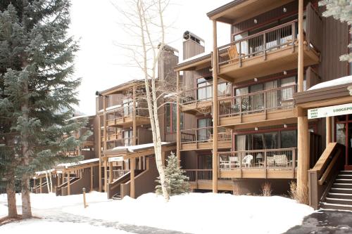 a building with snow in front of it at Evergreen Condominiums by Keystone Resort in Keystone
