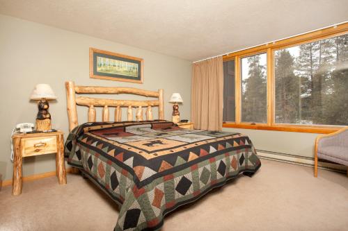 a bedroom with a bed and a window at Evergreen Condominiums by Keystone Resort in Keystone