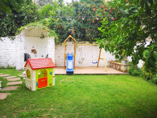 a backyard with a play yard with a play house at The Foria House by House In Naples in Naples