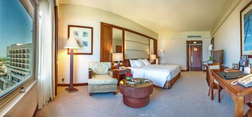 a large hotel room with a bed and a desk at Danat Jebel Dhanna Resort in Jebel Dhanna
