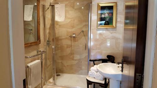 a bathroom with a shower and a sink at Heather House in Laragh