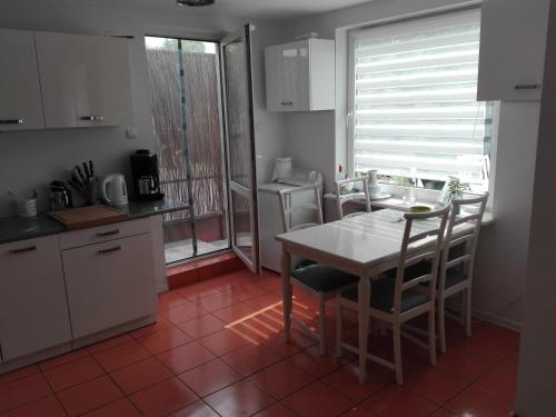 a kitchen with a table and chairs in a room at Dom Zaufanie in Uniejow