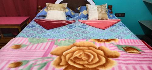a bed with a stuffed animal on top of it at Gopi Homestay in Hampi