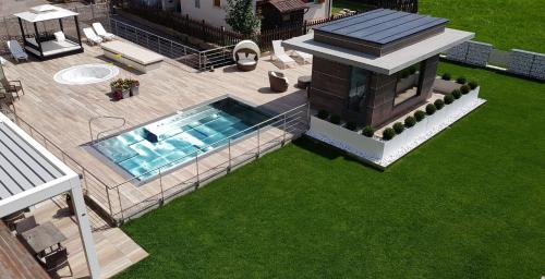 an overhead view of a house with a swimming pool at Dolce Avita Hotel Spa & Resort in Andalo