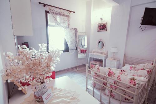 a living room with a couch and a table with flowers at Studio Lefaki in Rethymno Town