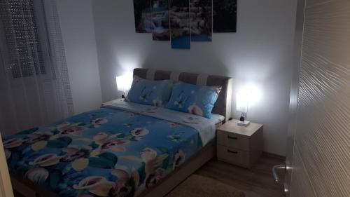a small bedroom with a bed and a night stand at Exclusive in Paraćin