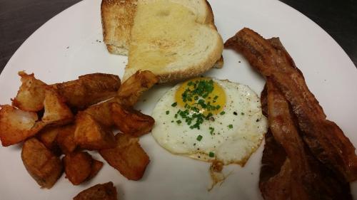 a white plate with eggs and potatoes and toast at The Exeter Inn in Exeter