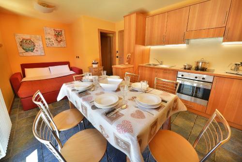 a dining room with a table and chairs and a kitchen at Chalet Matteo in Livigno