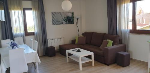 a living room with a couch and a table at Apartamentos La Pradera de Isla in Isla