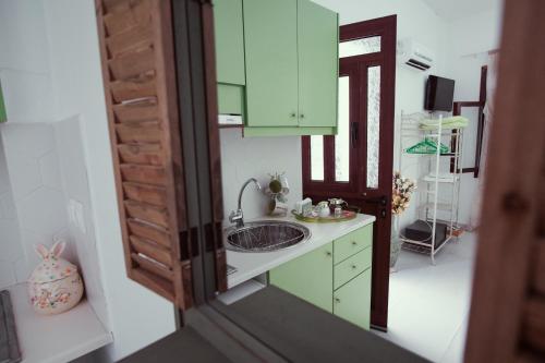a bathroom with a sink and a mirror at Studio Lefaki in Rethymno Town