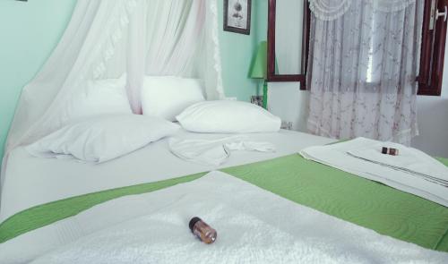 a white bed with a bottle on top of it at Studio Lefaki in Rethymno Town