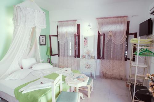 a bedroom with a bed and a table and chairs at Studio Lefaki in Rethymno Town