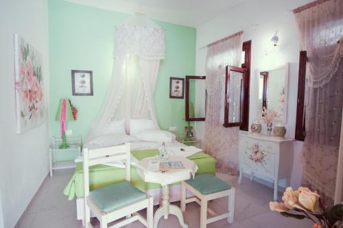 a bedroom with a bed and a table and chairs at Studio Lefaki in Rethymno Town