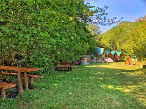 a group of picnic tables in a park with tents at Kamp Vrbnica in Pluzine