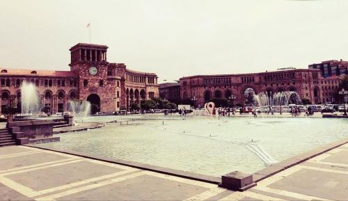 a large building with a fountain in front of it at Luxury Apartment with jacuzzi on Republic Square in Yerevan