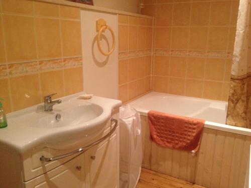 a bathroom with a sink and a bath tub at Self Catering for large groups, friends/families in Romagny