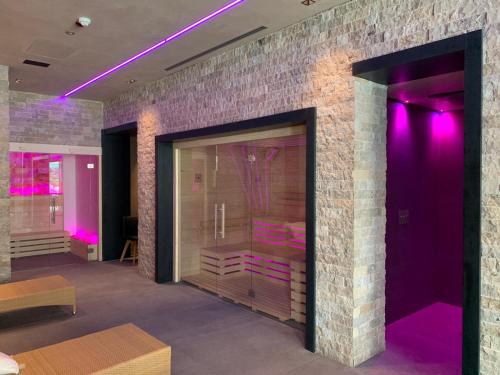 a room with purple lights on a brick wall at Hotel Terme Principe in Abano Terme
