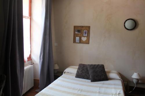 a bedroom with a bed and a window at Hôtel de Valdeblore in Valdeblore