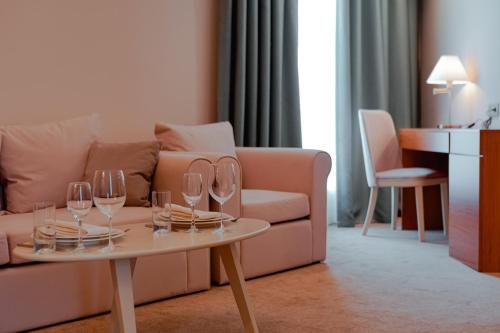 a living room with a couch and a table with wine glasses at Khazar Inji in Baku