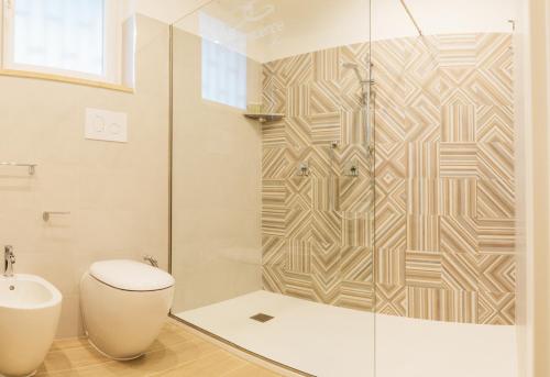a bathroom with a toilet and a glass shower at Golden Residence in Caianello