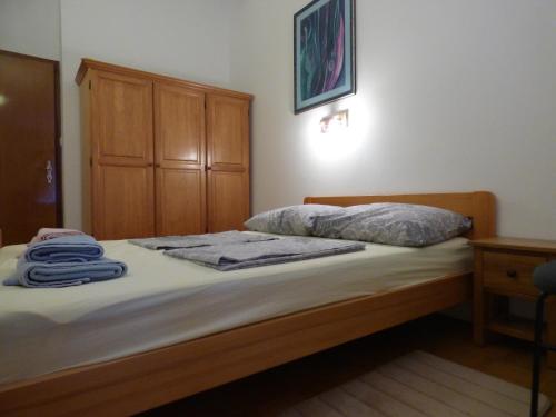 a bedroom with a bed with towels on it at HEDRA in Zambratija
