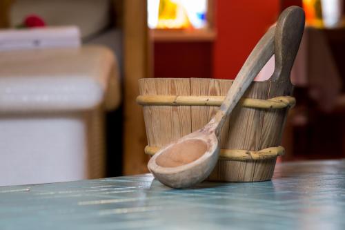a wooden spoon and a measuring cup on a table at Hotel Selsky Dvur - Bohemian Village Courtyard in Prague