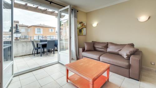 a living room with a couch and a table at Vacancéole – Le Domaine de Camiole in Callian