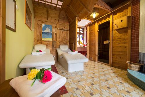 a bathroom with two sinks and a bath tub at Hotel Selsky Dvur - Bohemian Village Courtyard in Prague
