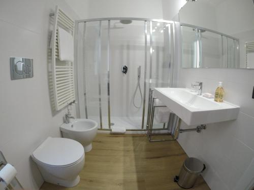 a bathroom with a toilet and a shower and a sink at Casa Marinin in Sestri Levante
