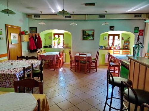 a restaurant with tables and chairs in a room at Dom Pristava in Jesenice