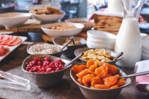 a table topped with bowls of fruit and other foods at Galgorm in Ballymena
