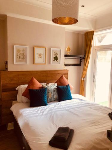 a bedroom with a large white bed with colorful pillows at Maritime Pods in Portsmouth
