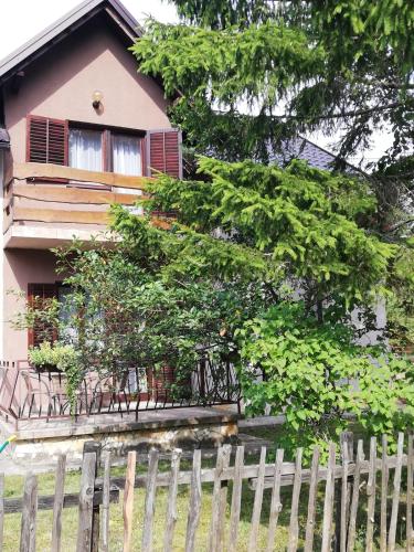 a house with a fence in front of it at Holiday Home "Iris" near Plitvice Lakes in Rudanovac